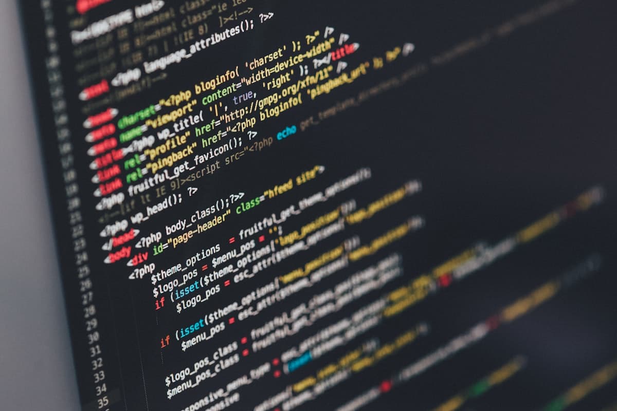 Lines of source code on a dark editor screen, photographed at a shallow angle